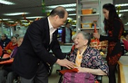 Mr Cheung (left) expresses warm regards and well wishes to an elderly resident.