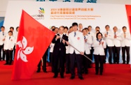 Mr Cheung presents flag to the Hong Kong Delegation.
