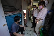 The Secretary for Labour and Welfare, Mr Chris Sun, visited grassroots citizens in Sham Shui Po, before meeting with grassroots families, students, elderly persons and street sleepers this afternoon (July 29). Photo shows Mr Sun (second right), accompanied by the Deputy Director of the Society for Community Organization, Ms Sze Lai-shan (first right), taking a closer look at the living conditions of grassroots citizens.