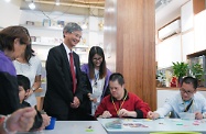 The Secretary for Labour and Welfare, Dr Law Chi-kwong, visited Central and Western District and called at Tung Wah Group of Hospitals Lok Kwan District Support Centre in Sai Ying Pun. Photo shows Dr Law (fourth right) watching persons with disabilities playing with beads for training eye-hand co-ordination.