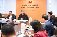 The Secretary for Labour and Welfare, Dr Law Chi-kwong, visited Central and Western District. Photo shows Dr Law (second left) meeting with the Chairman of the Central and Western District Council, Mr Yip Wing-shing (first left), and members to discuss labour and welfare matters.