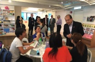 Mr Cheung (first right) chats with parents who are users of the service programmes operated by the centre.