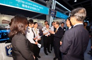 Mr Cheung (fourth right) chats with young employees of Aviation Security Company Limited.