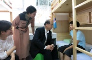 The Secretary for Labour and Welfare, Mr Matthew Cheung Kin-chung (second right), visited the Christian Family Service Centre Shing Shun Small Group Home in Tseung Kwan O this morning. Picture shows Mr Cheung observing the living environment and chatting with a child resident in the home. On his side are the Centre's Senior Programme Director, Ms Ivy Leung (first left), and Service Manager, Ms Teresa Lam (second left).