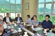 The Secretary for Labour and Welfare, Mr Matthew Cheung Kin-chung, went to Hong Kong Jockey Club Shenzhen Society for Rehabilitation Yee Hong Heights (Yee Hong Heights) in Yantian, Shenzhen to visit the Hong Kong elderly citizens residing there. Photo shows Mr Cheung (fourth right); the Permanent Secretary for Labour and Welfare, Miss Annie Tam (third right) and the Assistant Director of Social Welfare (Elderly), Ms Pang Kit-ling (second right), being briefed by the Chairman of the Hong Kong Society for Rehabilitation, Mr Benny Cheung (first left) on the updated position of the Yee Hong Heights services.