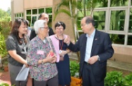 During a tour of the facilities, Mr Cheung chats with some elderly residents from Hong Kong on their daily life in the home. Picture shows Mr Cheung chatting with a resident at the gardening corner.