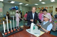 Mr Cheung chats with a resident receiving rehabilitation therapy.