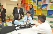 Mr Cheung tours the Jockey Club Fanling Integrated Children and Youth Services Centre operated by Hong Kong Children and Youth Services, where he was briefed on the after-school care programme offered by the centre.
