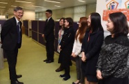 The Secretary for Labour and Welfare, Dr Law Chi-kwong, visited the Working Family Allowance Office for an update on the improved Working Family Allowance Scheme to be implemented on April 1. Photo shows Dr Law (first left) meeting with the Head of the Working Family and Student Financial Assistance Agency, Mr Esmond Lee (second left), and front-line staff.