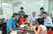 Mr Cheung (middle) chats with diners at the canteen on their needs and briefs them on new measures for the benefit of the public announced in the past two months.