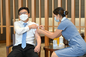 The Secretary for Labour and Welfare, Mr Chris Sun (left), receives seasonal influenza vaccination today (October 6).