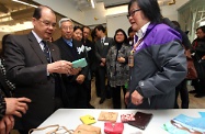 Mr Cheung (first left) tours the Jockey Club Amity Place to better understand its services for improving mental health.