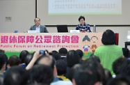 Mr Cheung (left) and Mrs Lam (right) listen to public views at the forum.