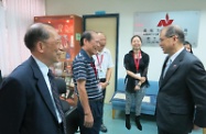 The Secretary for Labour and Welfare, Mr Matthew Cheung Kin-chung (first right), visits the Volunteer Action Centre of the Agency for Volunteer Service (AVS) and speaks with volunteers. Accompanying Mr Cheung is the Chairman of the AVS, Mr Lee Jark-pui (first left).