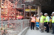 Mr Cheung (first left) views the various OSH measures implemented in the site.