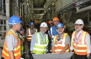 Mr Cheung (second right) is briefed by a representative of Dragages Hong Kong on the operation of the tunnel boring machines. First right is the Commissioner for Labour, Mr Donald Tong.