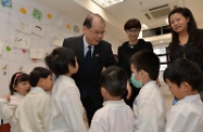 Mr Cheung (back row, left) was briefed by the Chief Executive Officer of St James' Settlement, Mrs Cynthia Luk (back row, centre) on the centre's child care services. He expressed thanks to child care centres in the Wan Chai and Central and Western districts which had remained open to provide essential support to parents in need during the recent class suspension of all kindergartens in the two districts.