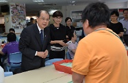 Accompanied by Mrs Cynthia Luk (second left), Mr Cheung (first left) paid a visit to a sheltered workshop of St James' Settlement.