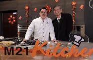 The Secretary for Labour and Welfare, Dr Law Chi-kwong, visited M21 Kitchen of the Hong Kong Federation of Youth Groups and took part in video-shooting for its "Neighbourhood First" programme. Photo shows Dr Law (right) pictured with the young hotel dessert chef, Mr Roger Fok.