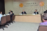 Mr Cheung (back row, second right) meets with the Chairman of the Kowloon City District Council, Mr Lau Wai-wing (back row, first right), and other District Council members to learn about local needs and concerns.