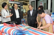 Mr Cheung (centre) is briefed by Ms Yau (first left) on the services offered in the sheltered workshop.