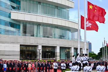 The Chief Executive, Mr John Lee, together with Principal Officials and guests, attends the flag-raising ceremony for the 73rd anniversary of the founding of the People's Republic of China at Golden Bauhinia Square in Wan Chai this morning (October 1).
