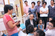 The Secretary for Labour and Welfare, Mr Matthew Cheung Kin-chung (centre), visited Lau Shun Man Fu Cheong Mutual Help Child Care Centre cum Women Services Centre (Fu Cheong Centre) in Fu Cheong Estate and Wai Yin Association Women Integrated Service Centre and Mutual Help Child Care Centre in Hoi Lai Estate, both operated by Kowloon Women's Organisations Federation (the Federation) in Sham Shui Po this afternoon (July 10).<br><br>

Photo shows Mr Cheung accompanied by the President of the Federation, Ms Zheng Zhen (second right, back row), its Chairman, Ms Ann So (fourth right, back row), and a number of District Council members when he visited the Fu Cheong Centre. Picture shows Mr Cheung listening to an introduction on the centre's child care services by the Chief Executive of the Federation, Ms Alice Wong (first left).