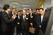 Mr Cheung (centre) tours the centre after the opening ceremony.