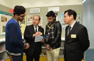 Mr Cheung (second left) and Mr Tong (first right) chat with two ethnic minority Employment Services Ambassadors to learn about their work.