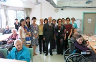 Mr Cheung (sixth right) is pictured with care and attention home staff and elderly residents.