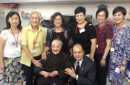 张建宗（前排右）与护理安老院的一名一百零七岁院友（前排左）及职员合照。