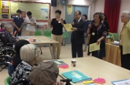 Mr Cheung (third right) participates in a word game with residents of the two care and attention homes.