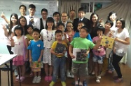 Mr Cheung (back row, fifth left) is pictured with the Centre's staff, volunteers and children receiving after-school care service.
