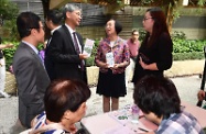 The Secretary for Home Affairs, Mr Lau Kong-wah; the Secretary for Labour and Welfare, Dr Law Chi-kwong; and the Secretary for Food and Health, Professor Sophia Chan, visited Kwai Tsing District. Photo shows Dr Law (second left) and Professor Chan (third left) visiting a pop-up health checkup station of the "Project e+: Dementia Community Support Service".