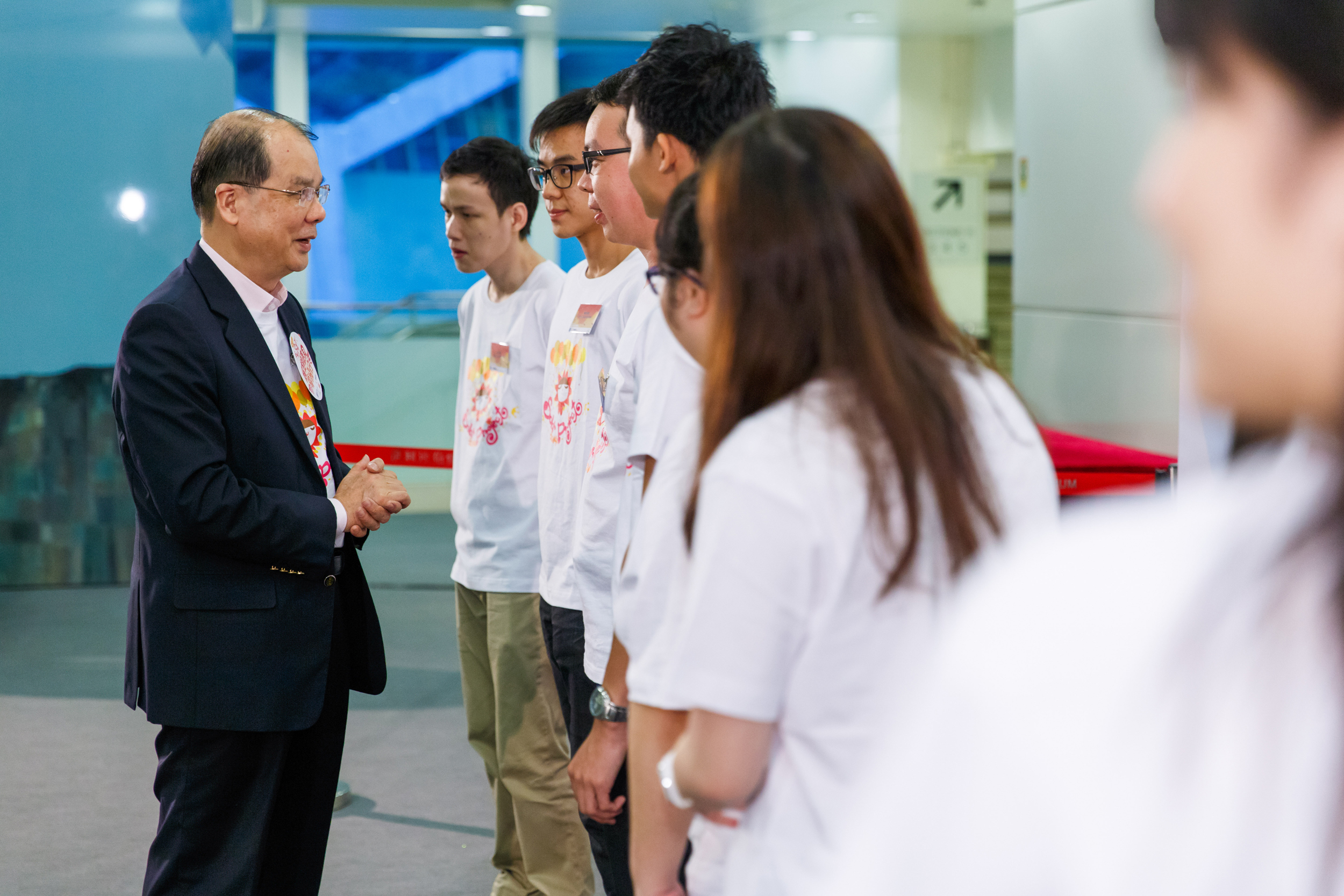 Mr Cheung (first left) chats with some of the Most Improved Trainees from the Youth Employment and Training Programme 2014.