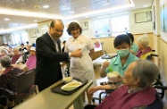 Mr Cheung (first left) observes how a trainee serves elderly people at the Oasis Nursing Home in Tsz Wan Shan.