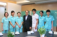 Mr Cheung (centre) is pictured with trainees of the Pilot Project on Multi-skills Workers Training at the Oasis Nursing Home. He encouraged them to grasp the opportunities of an ageing population to realise their career aspirations in the elderly service industry.
