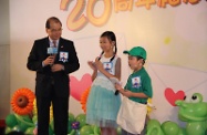 Mr Cheung (left) chats with two children during the ceremony. He also read out a reply letter he wrote in the name of "Uncle Long Legs".