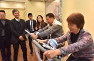 The Secretary for Labour and Welfare, Dr Law Chi-kwong, visited Kwun Tong District to tour the On Tat Neighbourhood Elderly Centre of the Tung Wah Group of Hospitals at On Tat Estate. Photo shows Dr Law (second left) being briefed on the services of the neighbourhood elderly centre.