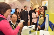 The Secretary for Labour and Welfare, Dr Law Chi-kwong, visited Kwun Tong District to tour the On Tat Neighbourhood Elderly Centre of the Tung Wah Group of Hospitals at On Tat Estate. Photo shows Dr Law (second left) being briefed on the services of the neighbourhood elderly centre.