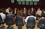 The Secretary for Labour and Welfare, Mr Matthew Cheung Kin-chung, visited Kwai Tsing District. Photo shows Mr Cheung (back row, centre), accompanied by the District Officer (Kwai Tsing), Mr Alan Lo (back row, second right), exchanging views with the Kwai Tsing District Council Chairman, Mr Fong Ping (back row, second left), and over 20 members of the Council on district needs and issues of concern.