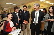 The Secretary for Labour and Welfare, Dr Law Chi-kwong, visited Southern District and called at the TWGHs Jockey Club Rehabilitation Complex in Aberdeen. Photo shows Dr Law (third right) and the Under Secretary for Labour and Welfare, Mr Caspar Tsui, visiting a person with speech impairment (first left) communicating with a speech-generating device.
