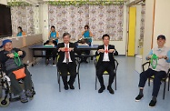 The Secretary for Labour and Welfare, Dr Law Chi-kwong, visited Southern District and called at the TWGHs Jockey Club Rehabilitation Complex in Aberdeen. Photo shows Dr Law (front row, second left) and the Chairman of Southern District Council, Mr Chu Ching-hong (front row, second right) participating in physical and mental revitalisation therapy with elderly people.