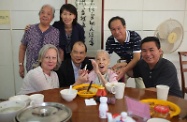 Mr Cheung (front row, second left); the Director of Social Welfare, Ms Carol Yip (back row, second left); and the Chairman of the Executive Committee of Helping Hand, Mrs Johanna Arculli (front row, first left), are pictured with a 100-year-old resident in the aged home.