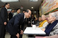 Mr Cheung chats with elderly visitors at the SAGE Eastern District Elderly Community Centre.