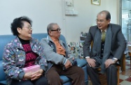 The Secretary for Labour and Welfare, Mr Matthew Cheung Kin-chung, visited some elderly residents in Lok Man Sun Chuen in Kowloon City to express his care and warm wishes for the festive season. Photo shows Mr Cheung (first right) chatting with an elderly couple, who he praised for realising the "active ageing" concept through regular participation in voluntary work and Cantonese opera performances.