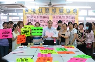 Mr Cheung (centre) receives submission from the new immigrant women.