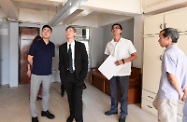 The Secretary for Labour and Welfare, Dr Law Chi-kwong, visited Yau Tsim Mong District and called at the SOUK housing unit of the Society of Rehabilitation and Crime Prevention, Hong Kong, in Yau Ma Tei. Photo shows the Chairman of Yau Tsim Mong District Council, Mr Chris Ip (first left) and Dr Law (second left) being briefed by the honorary designer and property owner on its design.