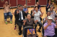 The Secretary for Labour and Welfare, Dr Law Chi-kwong, visited Yau Tsim Mong District and called at the Mong Kok Kai Fong Association Chan Hing Social Service Centre. Photo shows Dr Law (second left) joining the centre's elderly in a game.