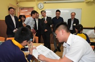 The Secretary for Labour and Welfare, Dr Law Chi-kwong, visited Yau Tsim Mong District and called at the Mong Kok Kai Fong Association Chan Hing Social Service Centre. Photo shows Dr Law (third right) watching a homework guidance class for newly arrived pupils held in the centre.